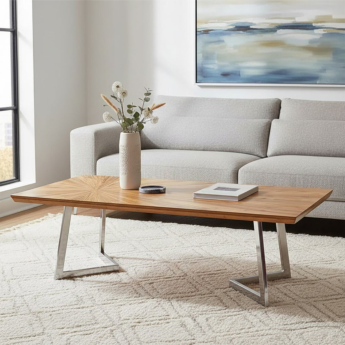 Modern living room with a wooden coffee table, gray sofa, and abstract painting.