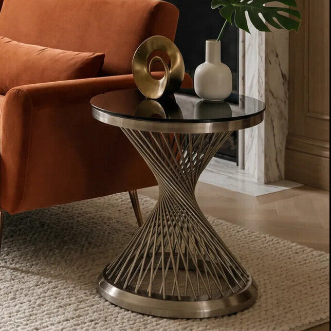 Orange sofa in a living room with a side table and decorative items.