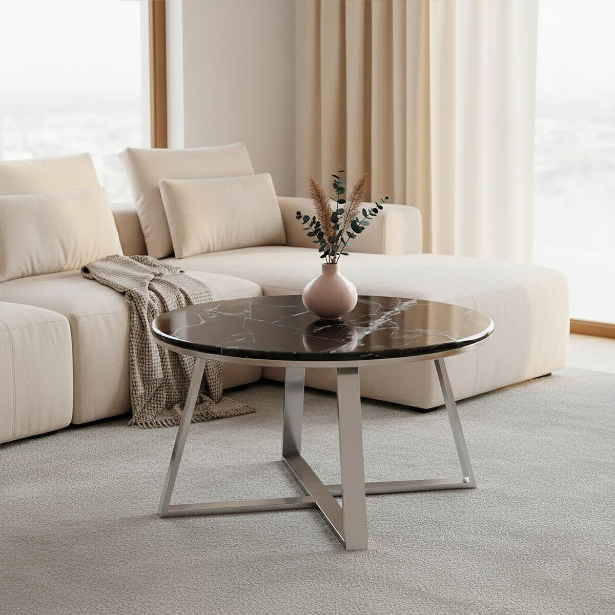 Modern living room with a beige sofa and a round coffee table.