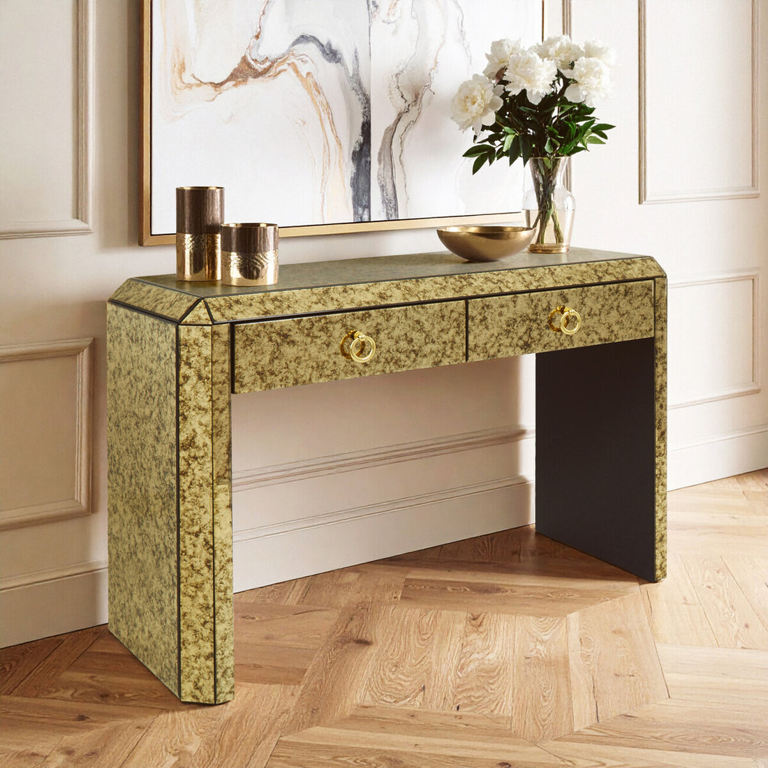 Decorative console table with floral arrangement and decor items in a room setting.