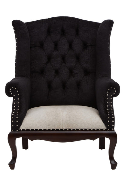 Black tufted armchair with white cushion on a white background