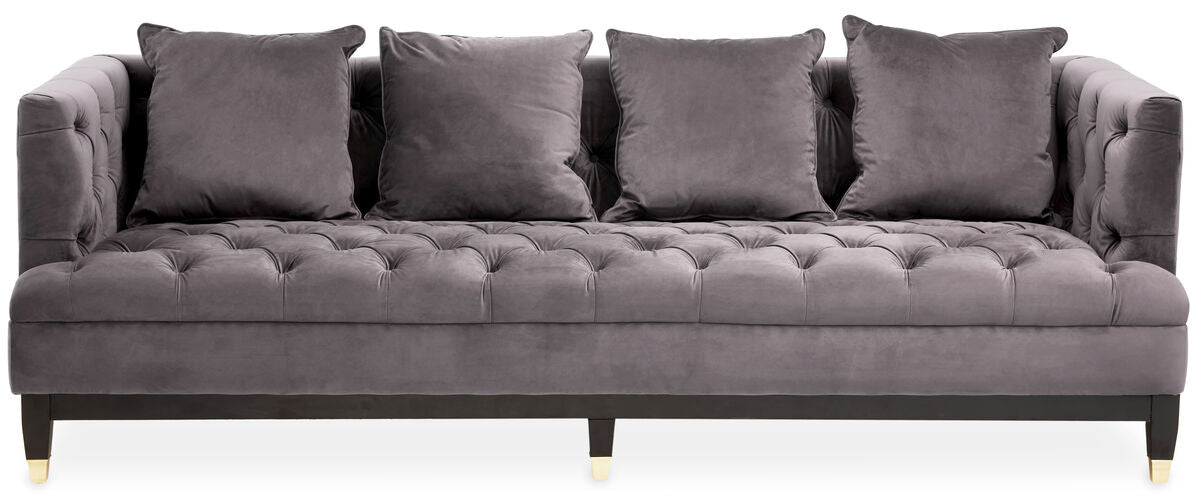 Gray tufted sofa with four cushions on a white background