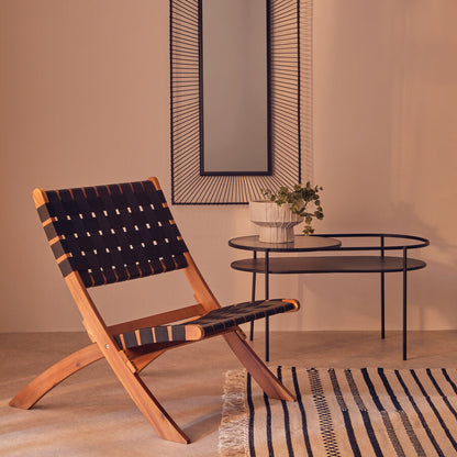 Modern chair with woven backrest in a room with a mirror and small table.
