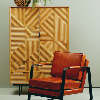 Wooden cabinet with geometric pattern and brown leather chair against a light gray background