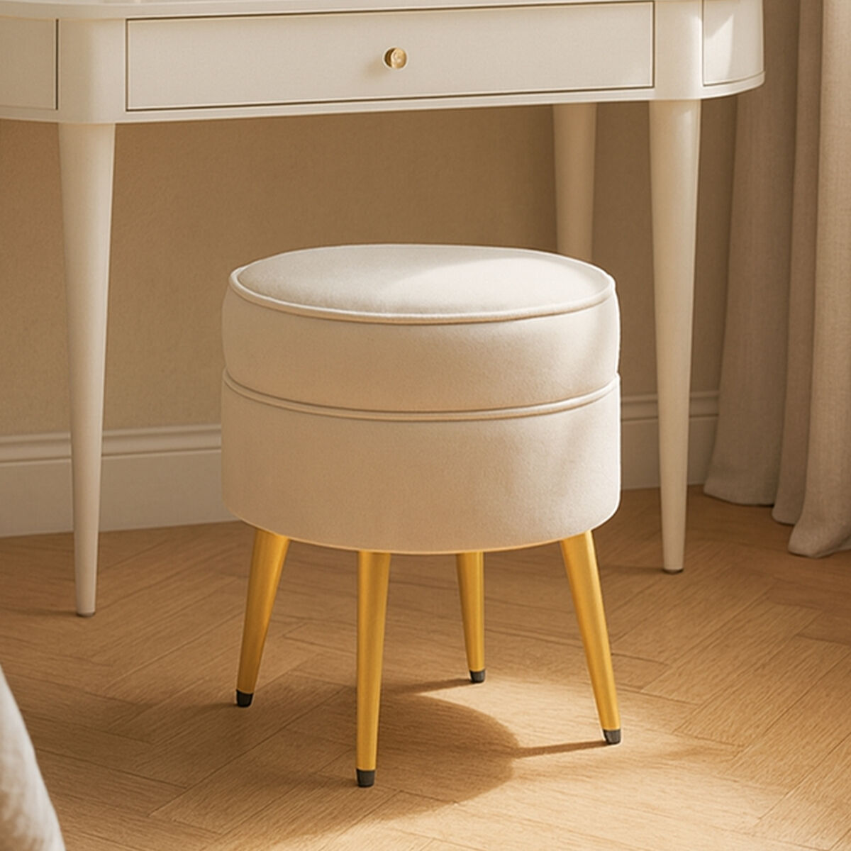 Round beige cushioned stool with yellow legs in front of a white desk.