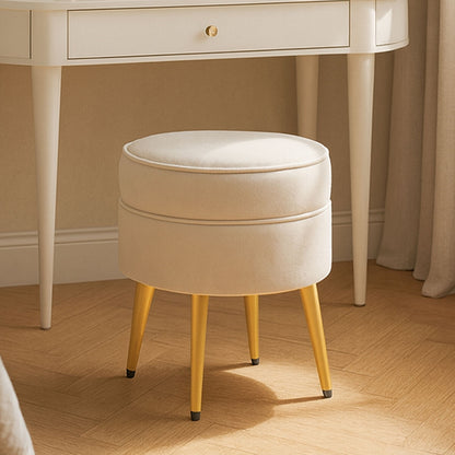Round beige cushioned stool with yellow legs in front of a white desk.