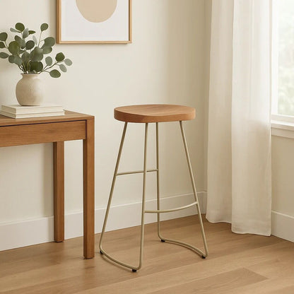 Wooden bar stool next to a wooden table with a plant in a room.