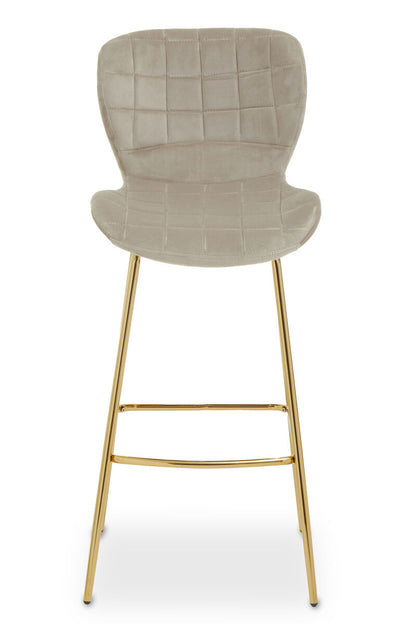 Bar stool with quilted beige seat and gold metal legs on a white background
