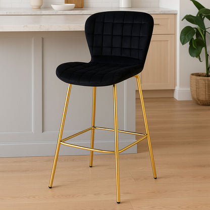 Black bar stool with gold legs in a kitchen setting