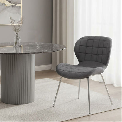 Dining room with a gray marble table and chair in a modern interior setting.