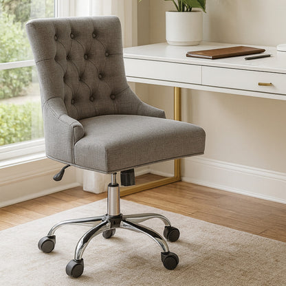 Gray office chair in a home office setting with a desk and window.