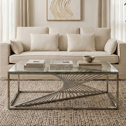 Modern living room with a beige sofa, glass coffee table, and abstract wall art.