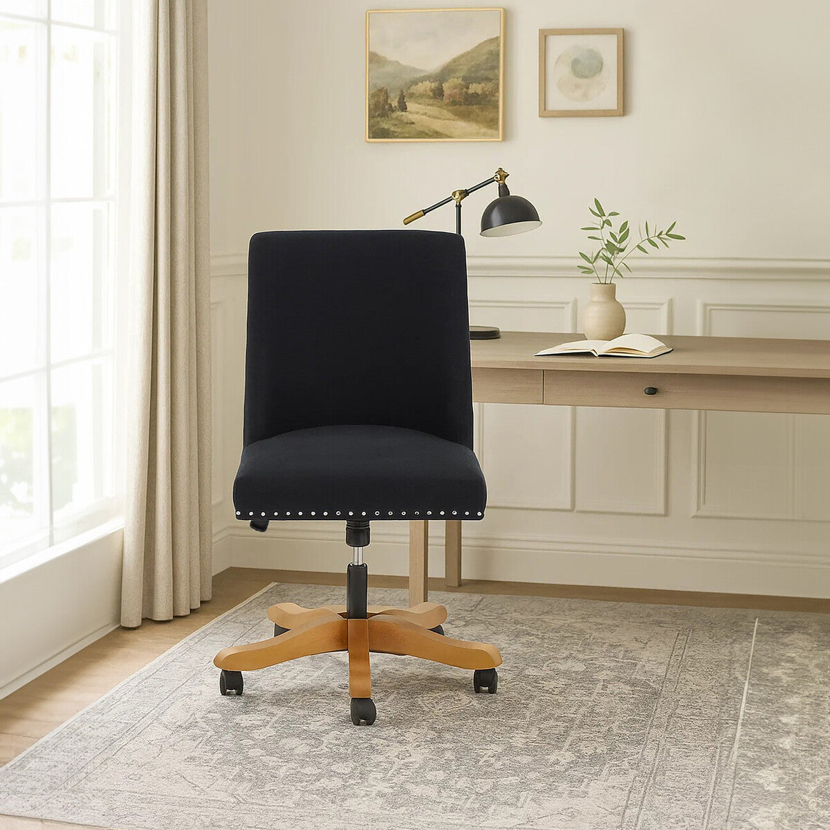 Black office chair in a home office setting with a desk and decor.