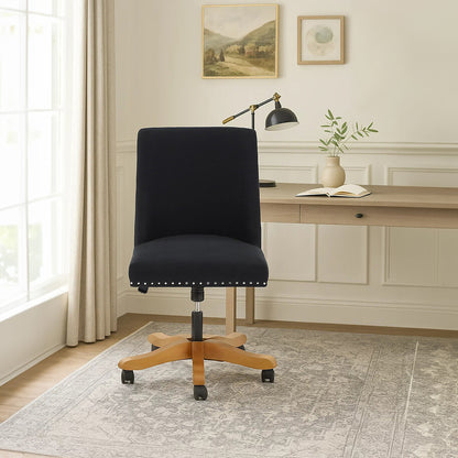 Black office chair in a home office setting with a desk and decor.