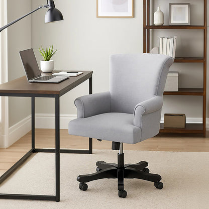 Gray office chair in front of a wooden desk with a laptop in a home office setting.