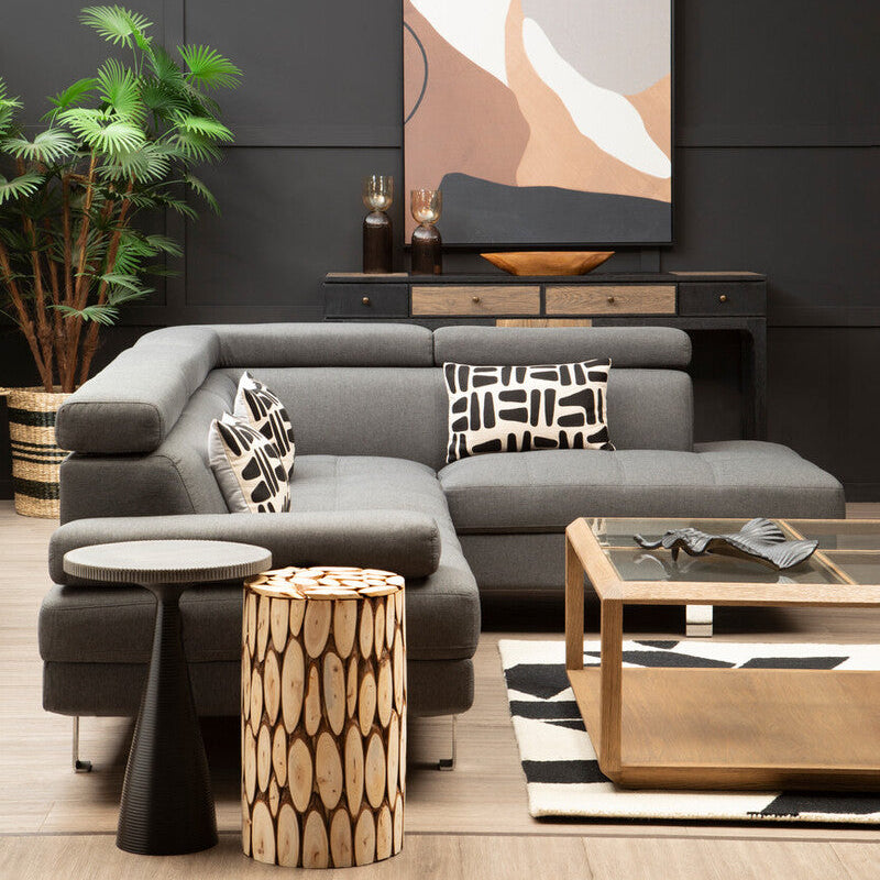 Modern living room with gray sectional sofa, wooden coffee table, and abstract wall art.