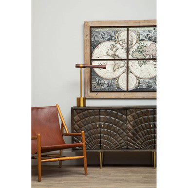 Cabinet with decorative map design above, brown chair to the left, and wooden floor.
