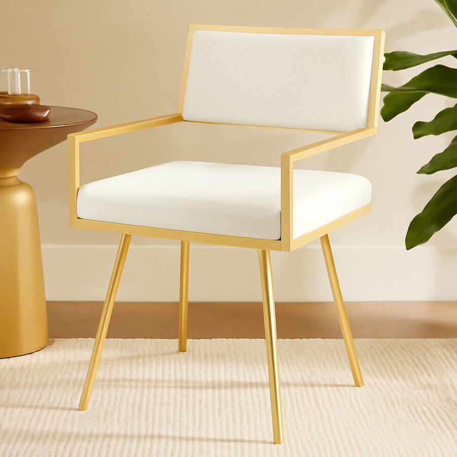 Modern chair with gold frame and white cushion in a room setting.
