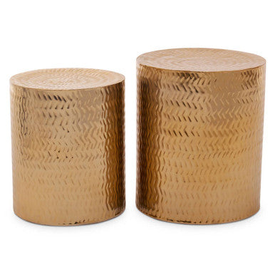 Two gold metal side tables with textured surface on a white background