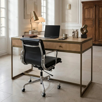 Modern office desk with black chair in a bright room