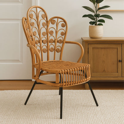 Wicker chair with black legs in a room with a wooden cabinet and plant.