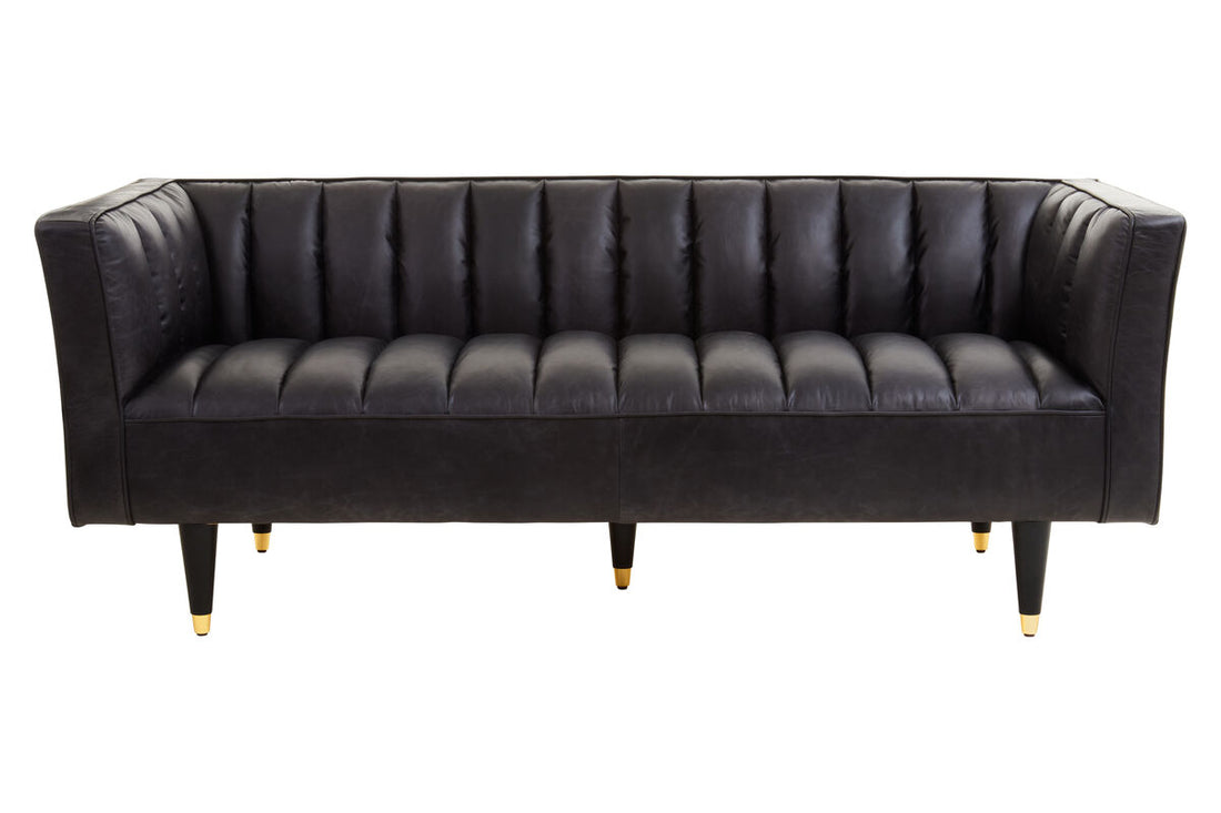 Black leather sofa on a white background