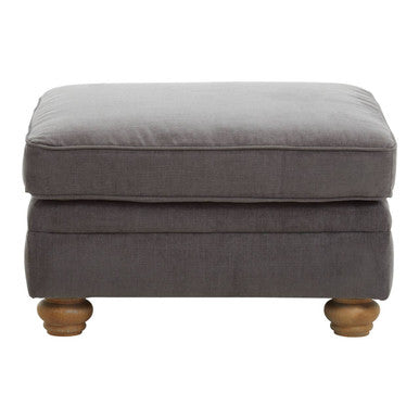 Gray upholstered ottoman with wooden legs on a white background
