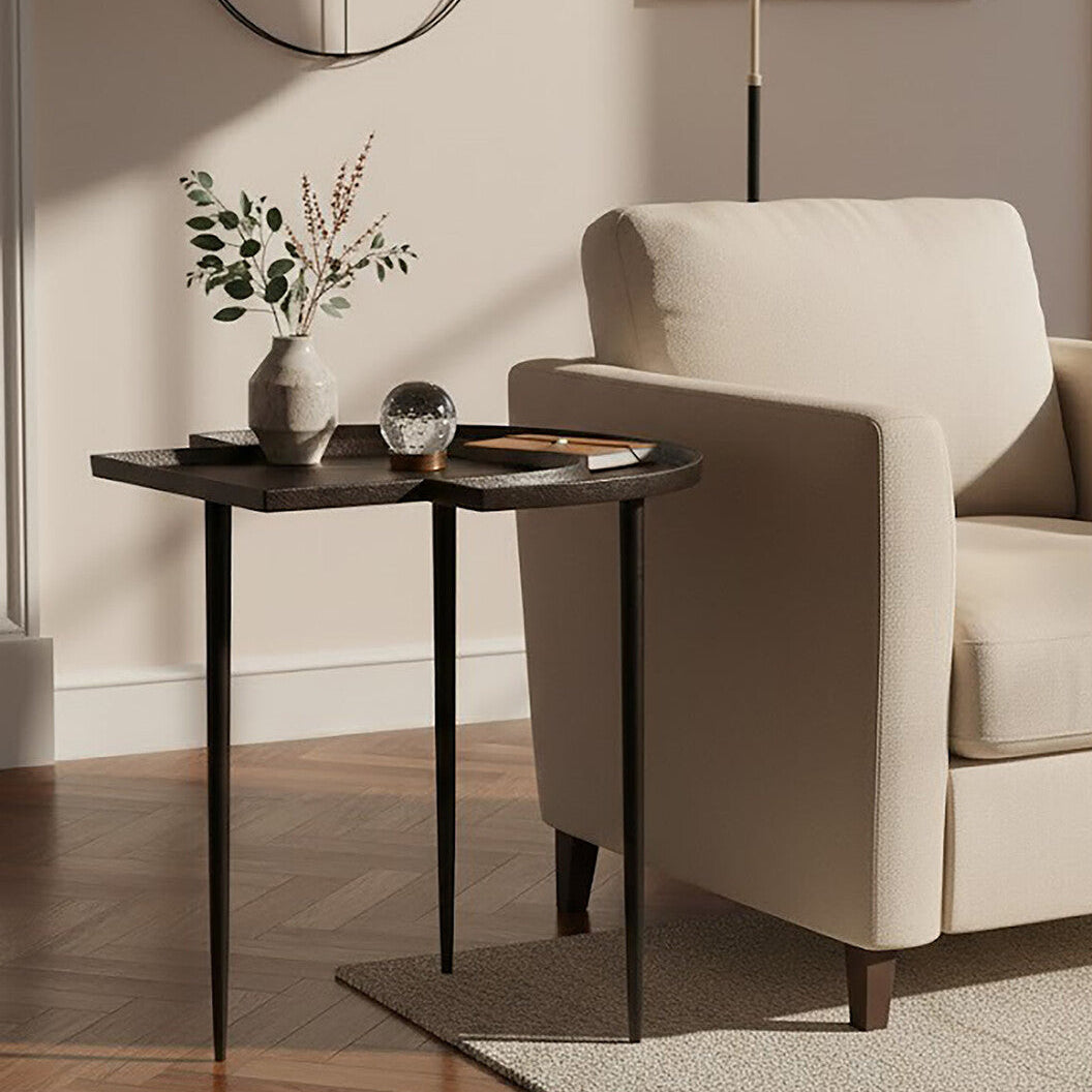 Beige armchair next to a small side table with decorative items in a living room setting.