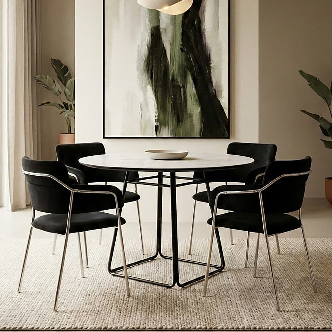 Dining room with a round table and black chairs, featuring a modern abstract painting on the wall.