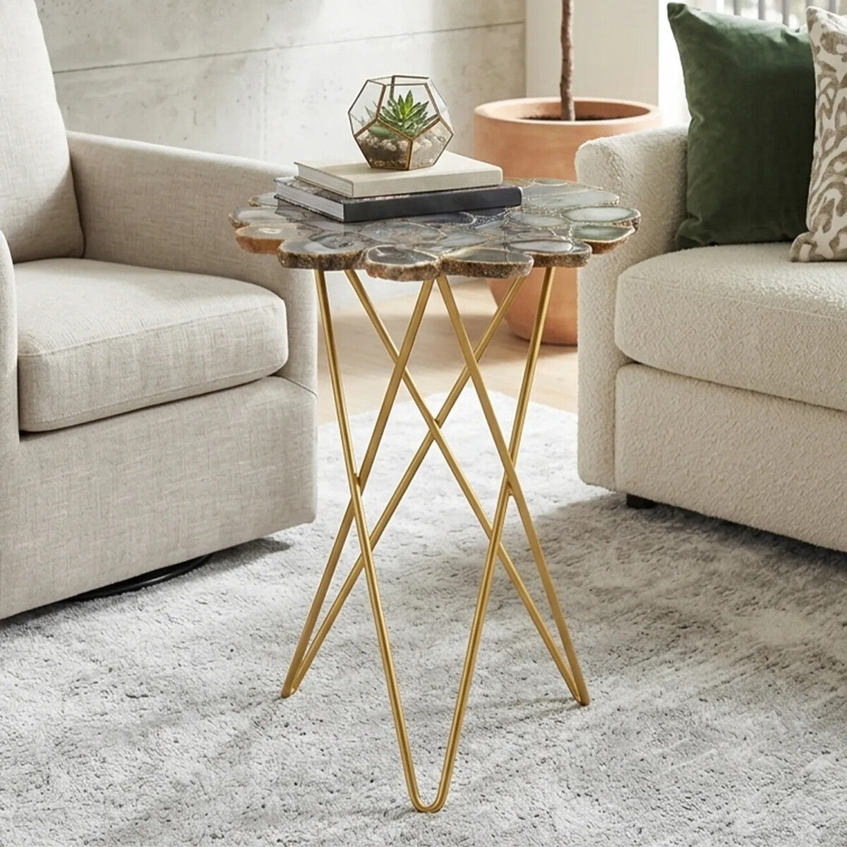 Small side table with gold legs and stone top in a living room setting