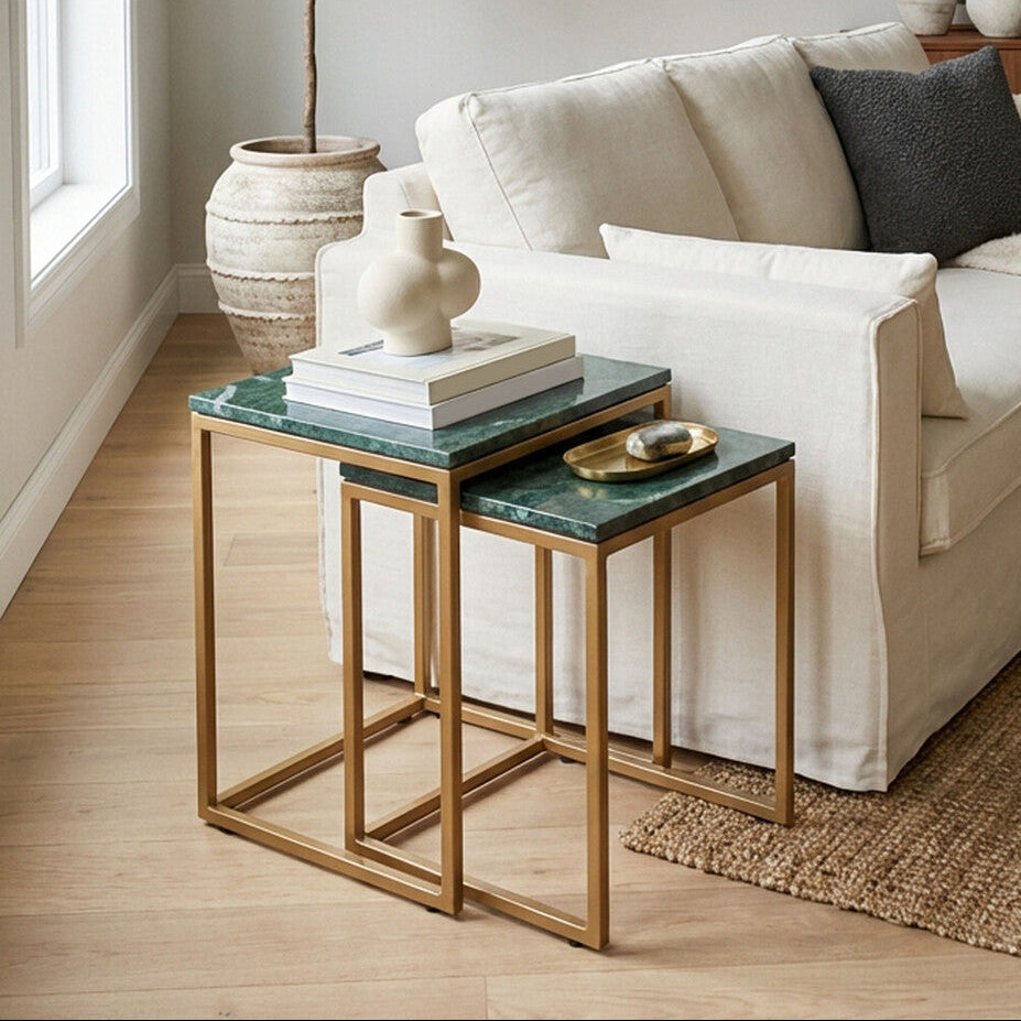 Living room with a beige sofa, nesting tables, and decorative items.