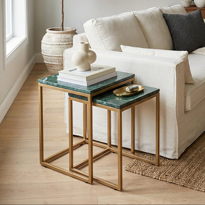 Living room with a beige sofa, nesting tables, and decorative items.