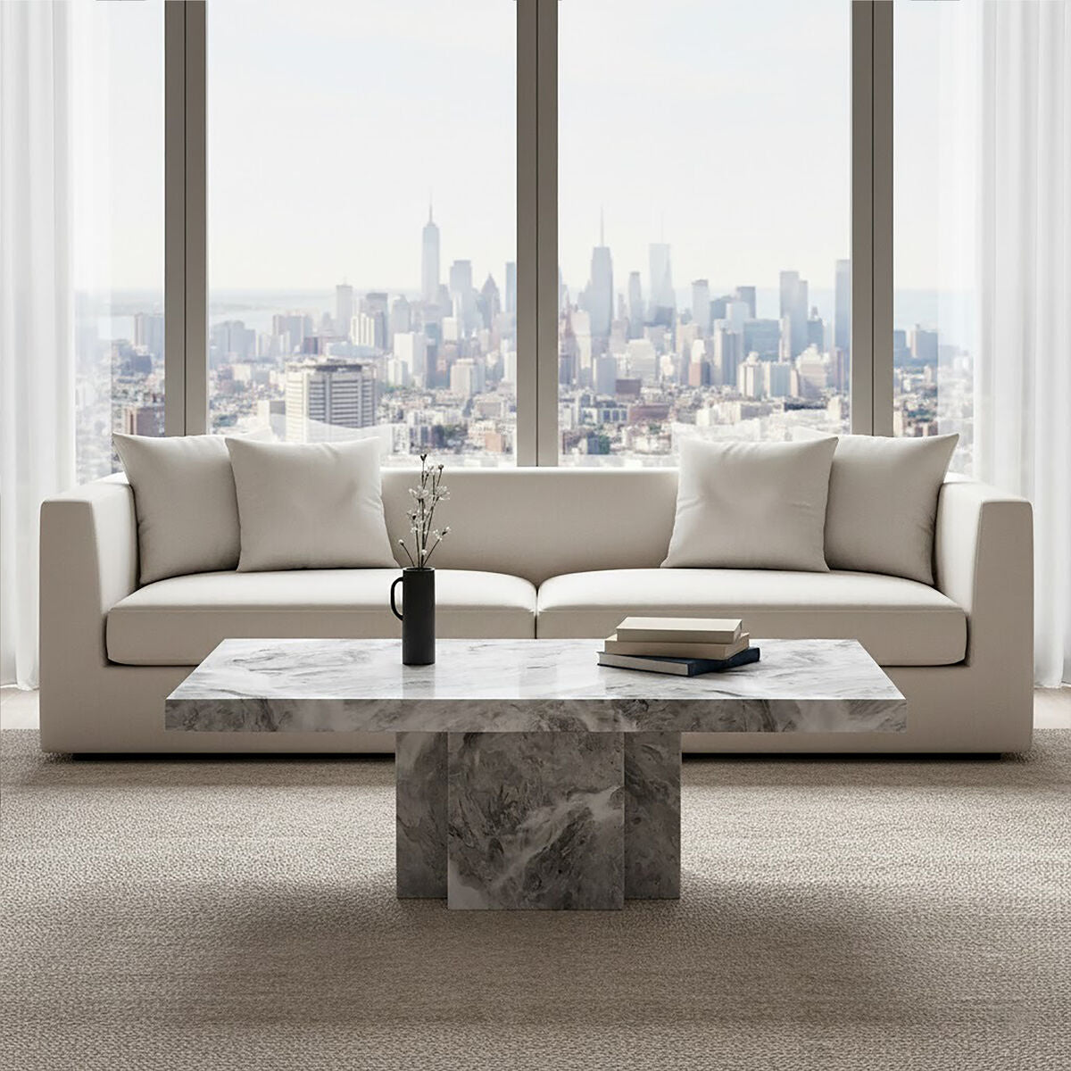 Modern living room with a beige sofa and marble coffee table in front of large windows with a cityscape view.