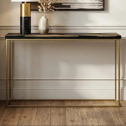 Modern console table with lamp and decor against a wall with abstract art