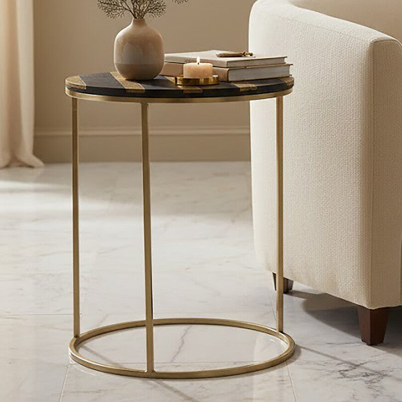 Beige armchair with a small round table featuring decorative items in a living room setting.