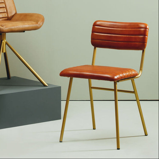 Two brown leather chairs with gold frames on a neutral background