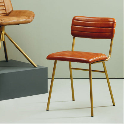 Two brown leather chairs with gold frames on a neutral background