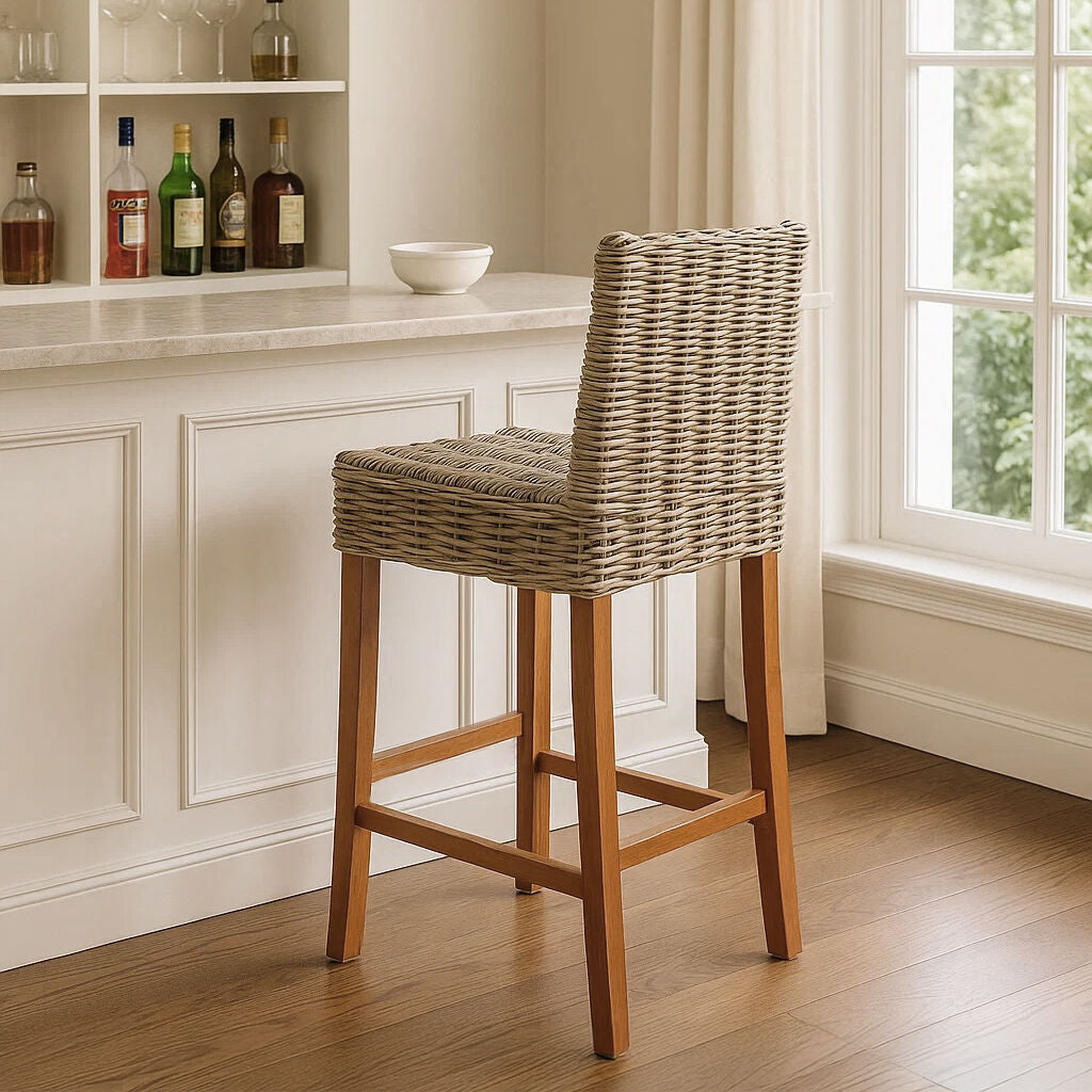 Wicker bar stool in a home setting with a window and shelves in the background.