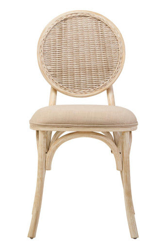 Wicker chair with beige cushion on a white background