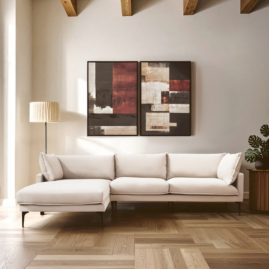 Modern living room with a white sectional sofa, abstract wall art, and wooden floor.