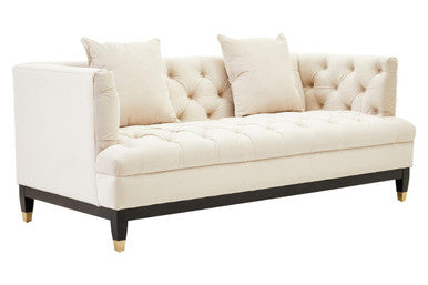 White tufted sofa with beige cushions on a white background