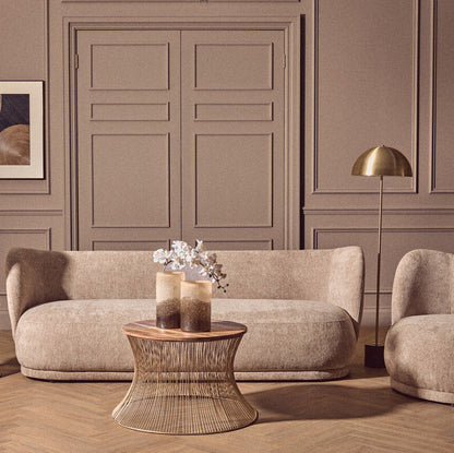 Modern living room with beige sofa, armchair, and side table.
