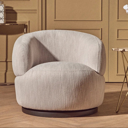 Modern beige armchair in a stylish room with decor elements.