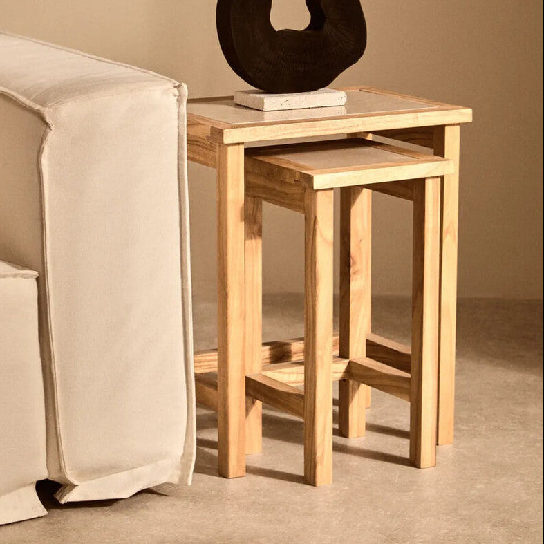 Wooden side table with a black sculpture in a living room setting
