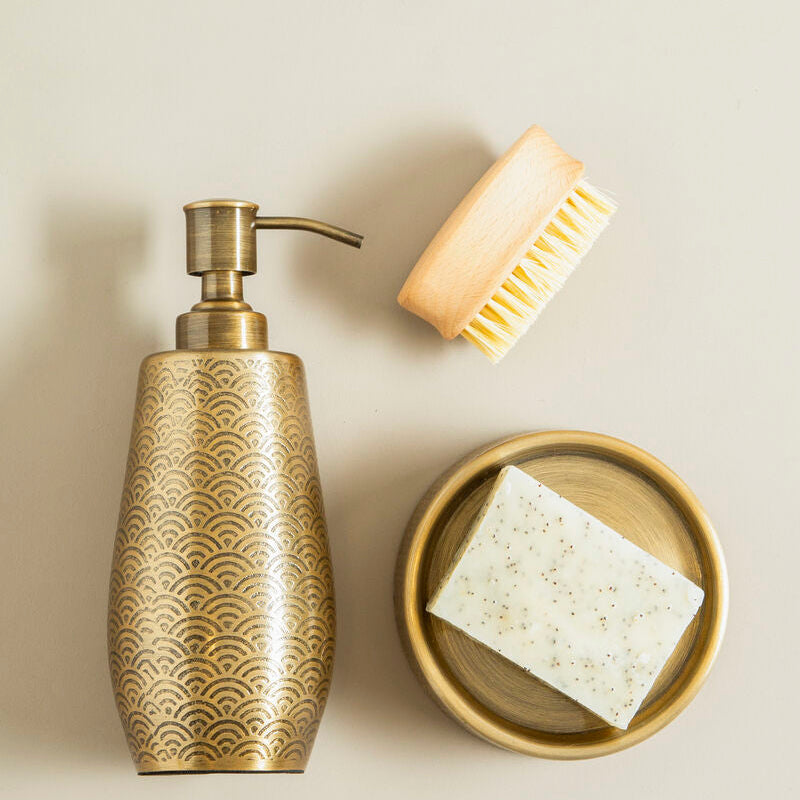 Decorative soap dispenser with a brush and soap bar on a beige background