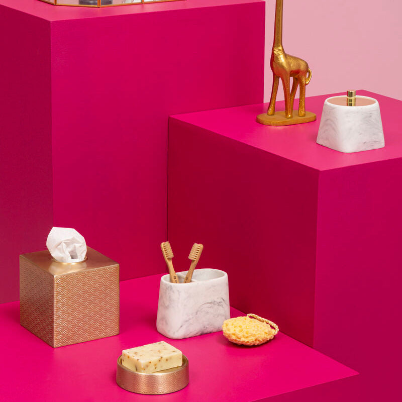 Decorative items on pink platforms with a pink background