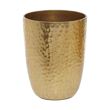 Gold hammered metal tumbler on a white background