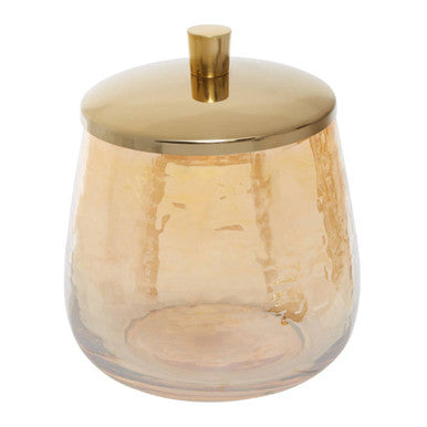 Glass container with a gold lid on a white background
