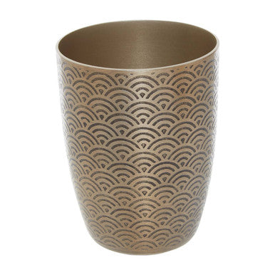 Beige ceramic cup with wave pattern on a white background