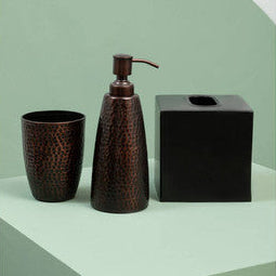 Bathroom accessory set with a dispenser, cup, and tissue box on a green and white background